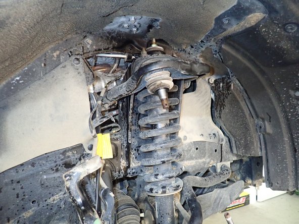 Raise upper arm to allow space to remove and install the shocks.