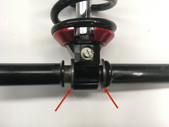 Install the sleeve through the bottom eye with the supplied plastic spacers on both side of the eyelet.