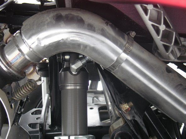 Install the rear right shock with the head at the top of vehicle and the hose going to the front of vehicle. (45 degrees angle).