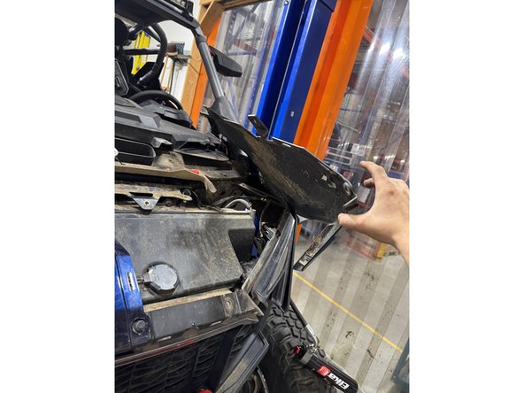 Pass the reservoir thru the fender as shown.