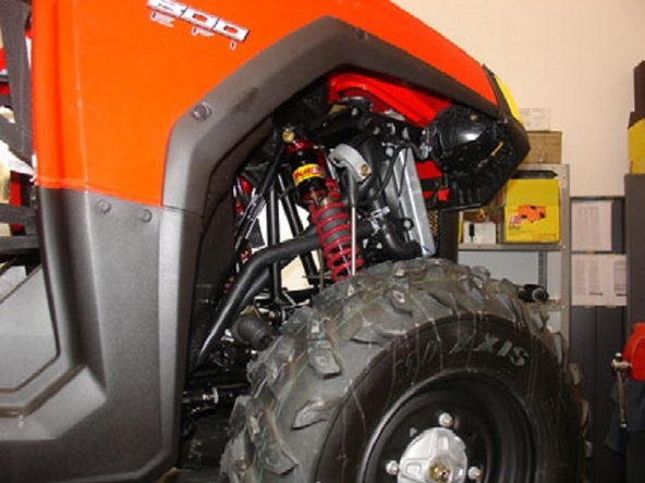 Tighten the top and bottom shock bolts to the proper manufacturer’s torque specifications.