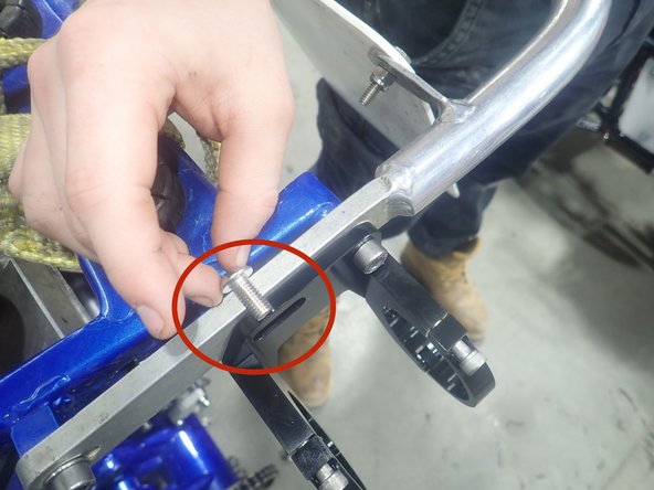 Install shock with hose fitting facing rear of atv.