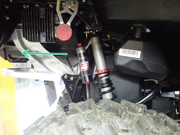 Install the right new Elka rear shock with the piggyback reservoir at the top and oriented towards the rear of the vehicle as indicated by the green Arrow on the photo.