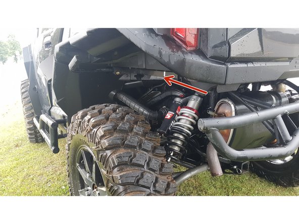 Install the left and right new Elka rear shock with the piggyback reservoir at the top and oriented towards the front of the vehicle as indicated by the red Arrow on the photo.