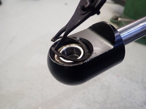 Using circlip pliers, remove both circlips.