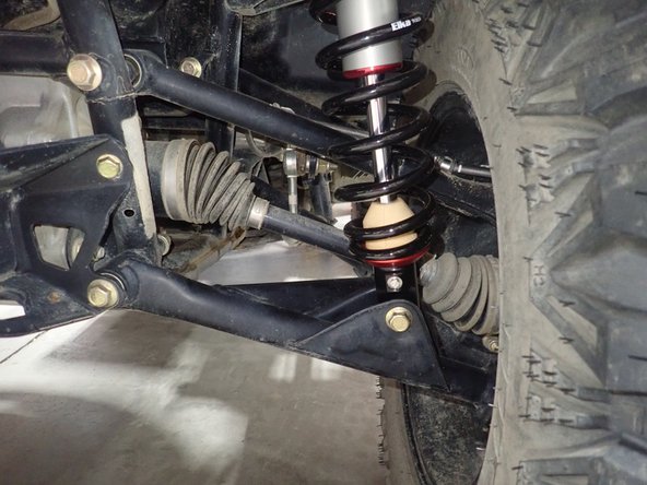On Stage 2, Stage 4, and Stage 5 models the rebound adjuster located on lower eyelet of the shocks should be oriented towards the rear of the vehicle, as shown. (Right side shown ). If needed, you can turn the lower eyelet to orient properly.