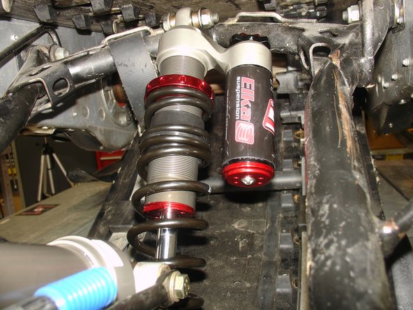 Install the Elka center shock with piggyback reservoir at the top and pointing towards the right side of the snowmobile as show on the photo.