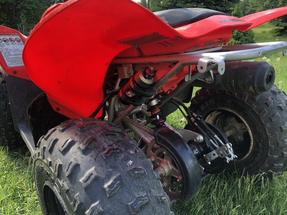 Install the new Elka rear shock with the remote reservoir at the top  and oriented towards the front of the vehicle as indicated by the blue circle on the photo.