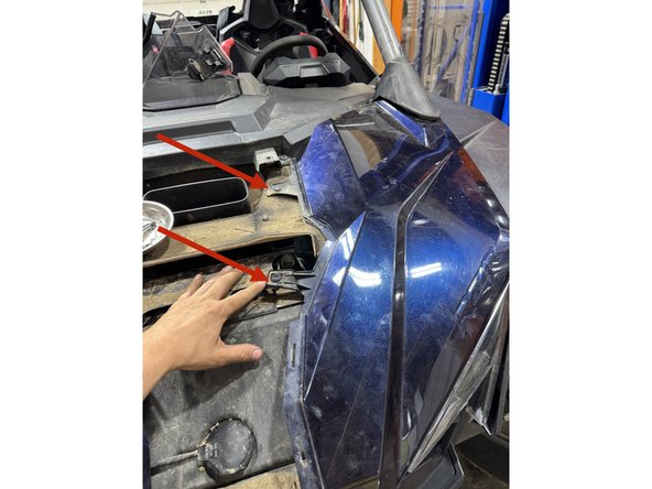 Lift the side panel as shown to make room for the reservoir.