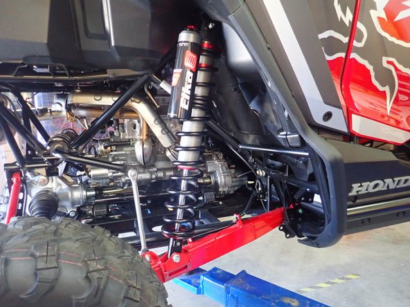 Install the new Elka rear shocks with the piggyback reservoir at the top and oriented towards the outside of the vehicle as indicated by the red Arrow on the photo. (Right side shown)