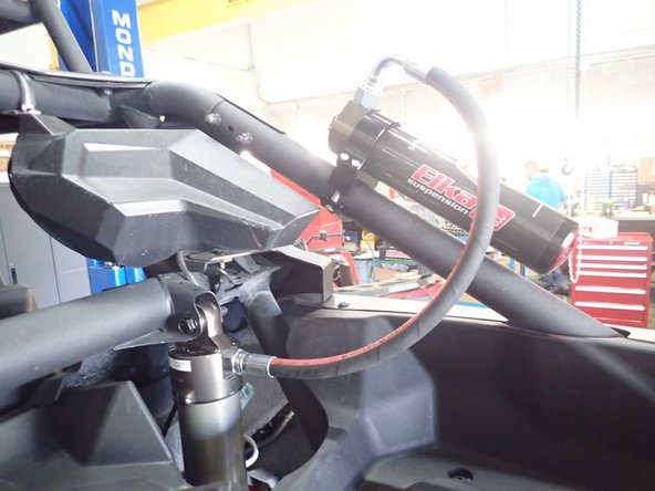 The reservoir is attache to the cage at the top with the hose facing upward.