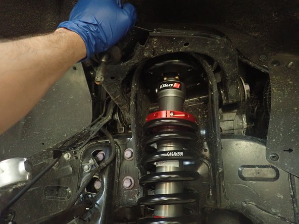 Install the new Elka shocks begining with putting the upper top plate in place. Then, push the lower suspension arm down, and put the lower eyelet of the shock in place.