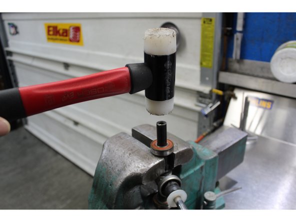 Remove the shaft assembly from the bottom of the centre shock.