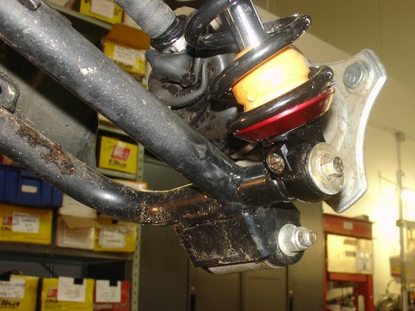 On Stage 2, Stage 4, and Stage 5 models the rebound adjuster located on lower eyelet of the shocks should be oriented towards the inside of the vehicle, as shown. (Left side shown ). If needed, you can turn the lower eyelet to orient properly.