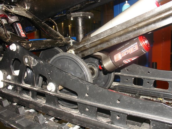 Install idler wheel on both side of the shock and slide them in is place until the bolts pass thru as shown on the pictures.