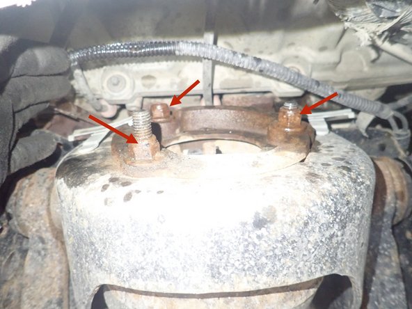 Remove the 3 upper shock nuts, except for the central nut.