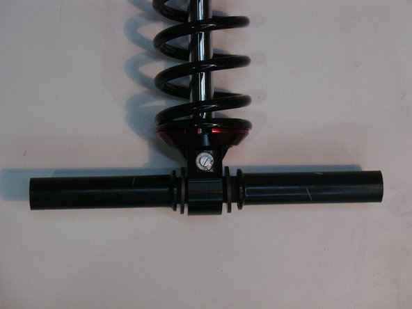 Install the sleeve through the bottom eye with the plastic spacer on both side of the eyelet.