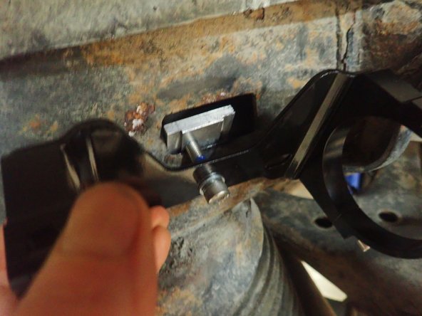 Insert rectangular piece in square hole, turn and position it properly to avoid rotation of part, and tighten in place at 20 Ft-Lb.