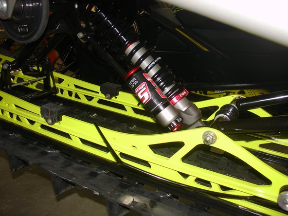 Remove the oem shock, and install the new Elka shock with the piggyback reservoir oriented toward the floor and the right of vehicle as shown.