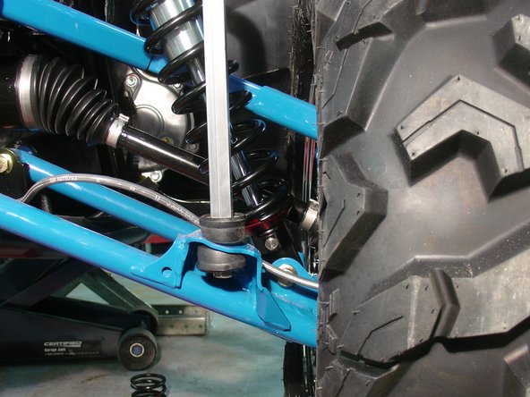 On Stage 2, Stage 4, and Stage 5 models the rebound adjuster located on lower eyelet of the shocks should be oriented towards the rear of the vehicle, as shown. (Right side shown ). If needed, you can turn the lower eyelet to orient properly.