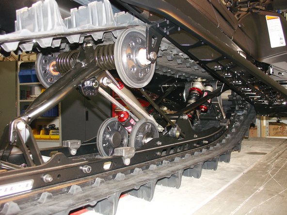 Install the Elka center shock with piggyback reservoir at the top and pointing towards the right side of the snowmobile as show on the photo.