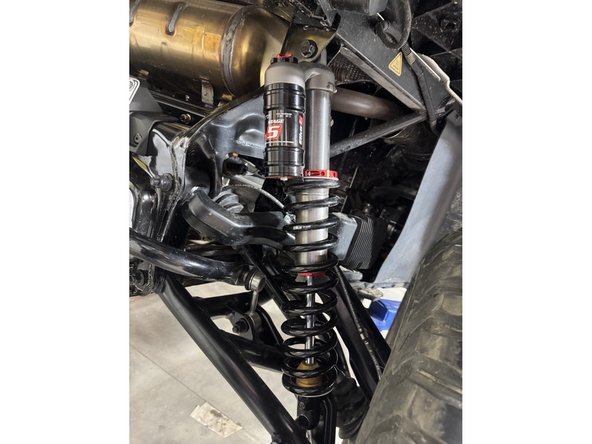 Install piggyback shock with the reservoir upward and facing the rear of the vehicle.