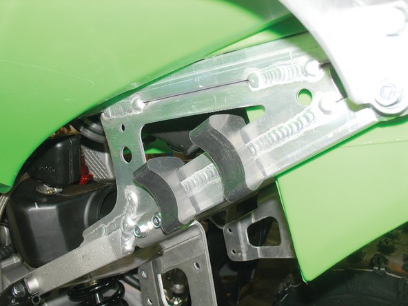 Install the provided rubber mounts on the left side of the rear subframe with the tab on top.