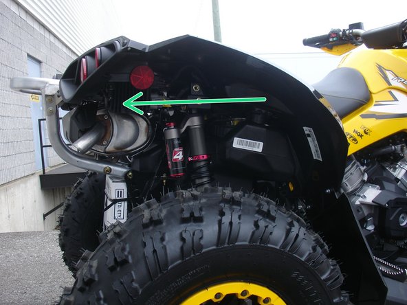 Install the right new Elka rear shock with the piggyback reservoir at the top and oriented towards the rear of the vehicle as indicated by the green Arrow on the photo.