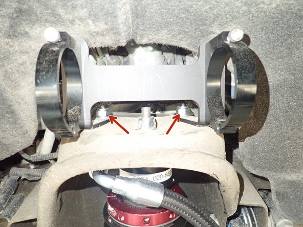 Reservoir bracket must be slide in the 2 rear studs (showed by red Arrow). You may have to push or cut fender guard to allow space for bracket.