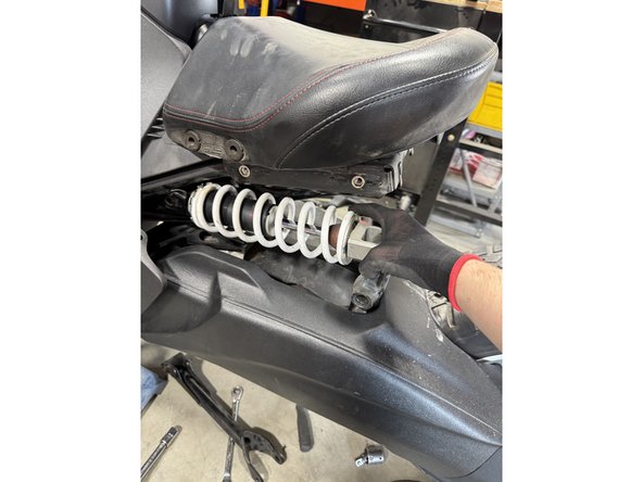 Remove the linkage bolt shown by the red arrow.