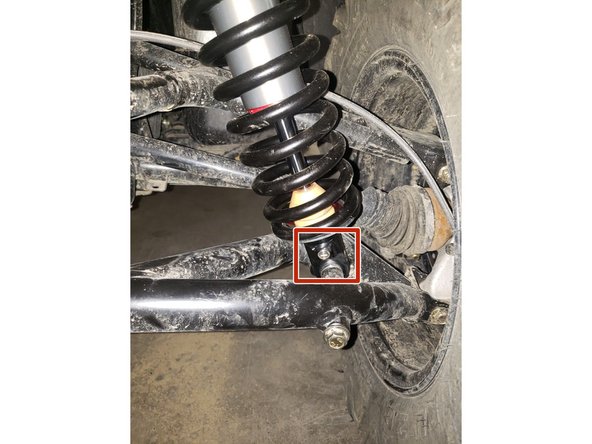 On Stage 2, Stage 4, and Stage 5 models the rebound adjuster located on lower eyelet of the shocks should be oriented towards the rear of the vehicle, as shown. (Shown by the red square ). If needed, you can turn the lower eyelet to orient properly.