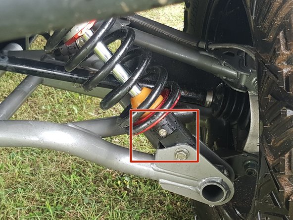On Stage 2, Stage 4, and Stage 5 models the rebound adjuster located on lower eyelet of the shocks should be oriented towards the rear of the vehicle, as shown. (Shown by the red square ). If needed, you can turn the lower eyelet to orient properly.