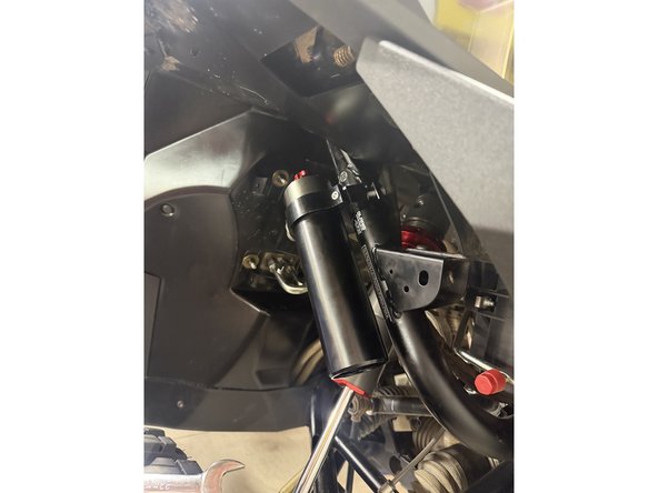 Note: The hose configurations differ between the left and right sides. Refer to the images to ensure the shocks are installed on the correct side. Right side shown.