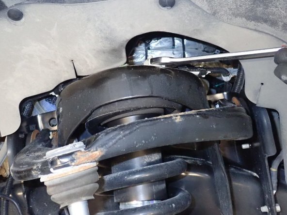 Remove the nuts from the upper and lower shock mounts.