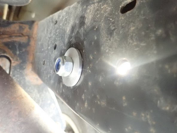 Use second spacer and provided nut to fix bracket in place.