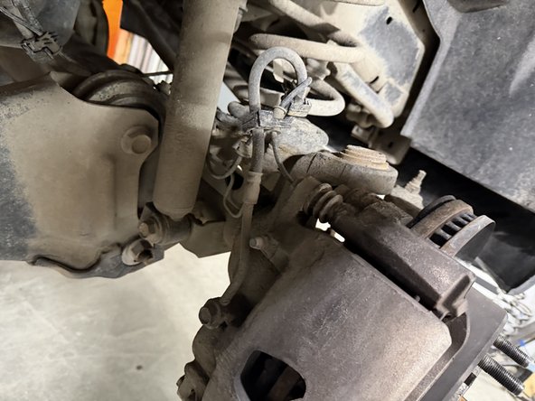 Remove upper nuts and lower bolts, then remove OEM shocks.