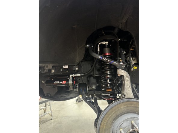 To complete front installation, put back upper arm,  sway-bar links, brake lines and wheels.