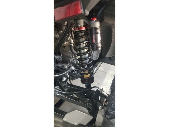 Install the left and right new Elka rear shock with the piggyback reservoir at the top. On Stage 1 and Stage 2, the left and the right shock are the same. Just install them with the shraeder nitrogen valve at the top of vehicle.