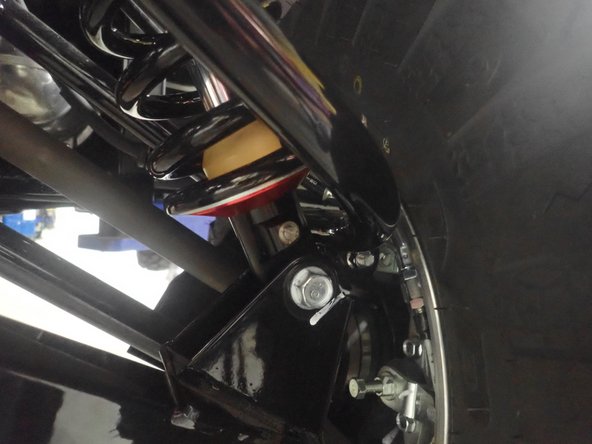 On Stage 2-4-5 models, the lower shock eyelets should be installed with the rebound adjuster oriented towards the rear of the vehicle as shown. If needed, you can turn the lower eyelet to orient properly.