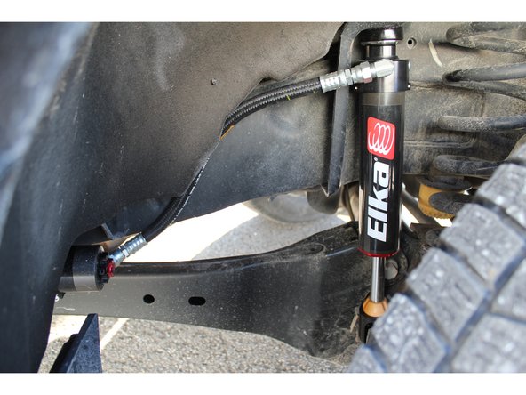 Turn shocks to have the hoses as close as possible to the frame, making sure avoid fittings interference, then tighten all bolts at OEM torque specs.