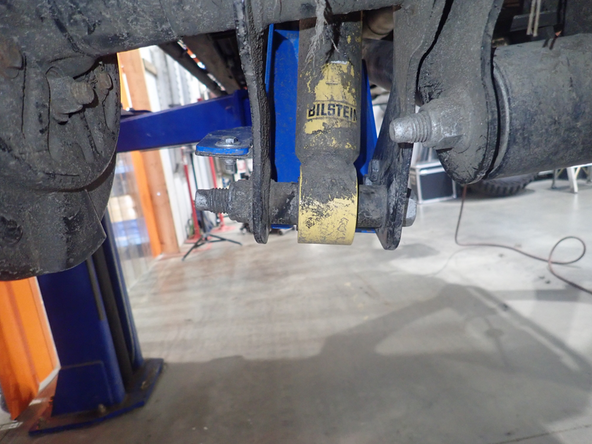 Remove the lower bots of the OEm shock.