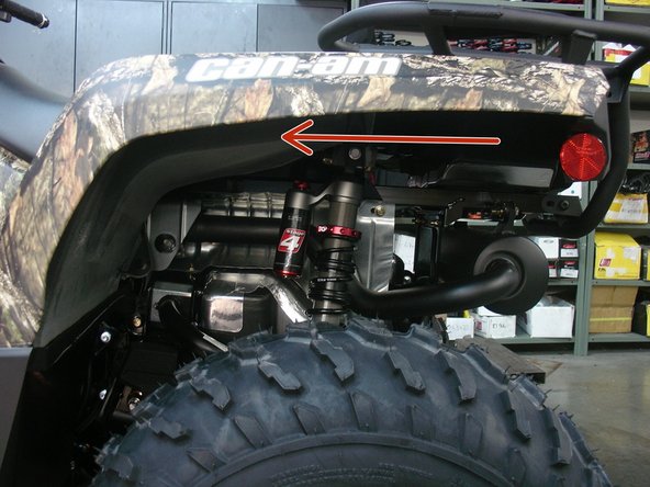 Install the left new Elka rear shock with the piggyback reservoir at the top and oriented towards the front of the vehicle as indicated by the red Arrow on the photo