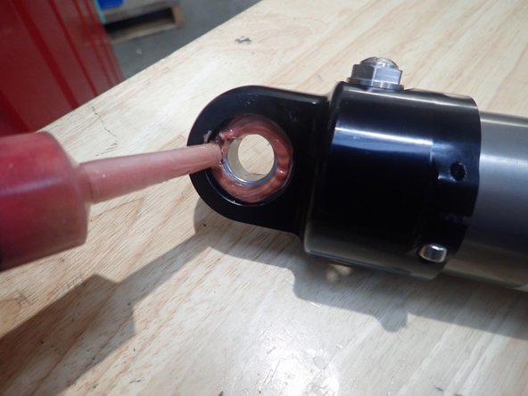 Install o-rings on provided upper mount spacers, then slide first spacer/o-ring on truck upper stud as shown by blue circle.