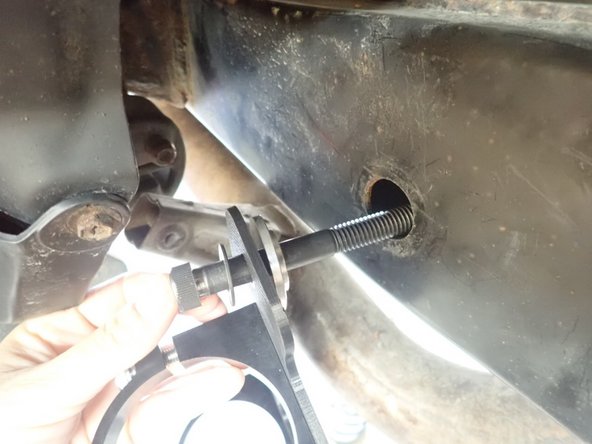 Slide right side bracket bolt into frame's hole with supplied hardware as shown. Be careful instaling spacers on the side with the smallest diameter into the frame's holes to center the bolt.