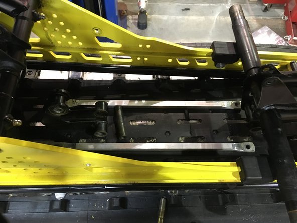 Remove the stock rear shock with both aluminium link.