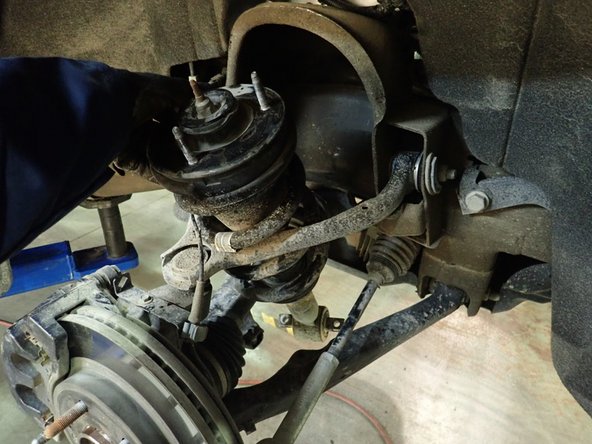To remove OEM shocks: push the bottom of shocks rearward, lower the shocks to clear frame upper mount, then take out the shocks from above the upper mount.