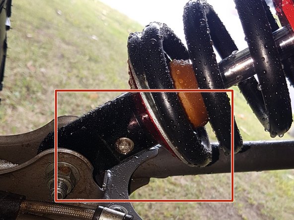 On Stage 2, Stage 4 and Stage 5 models, the lower shock eyelets should be installed with the rebound adjuster (red square) oriented towards the back of the vehicle as shown by the Red square on the photo ( left side shown ). If needed, you can turn the lower eyelet to orient properly.