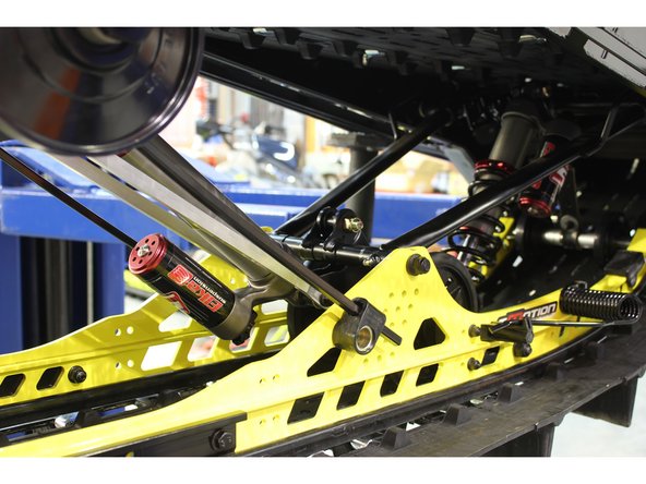 Install the Elka rear shock with the piggyback reservoir at the bottom and oriented towards the rear of the snowmobile as shown on the photo.