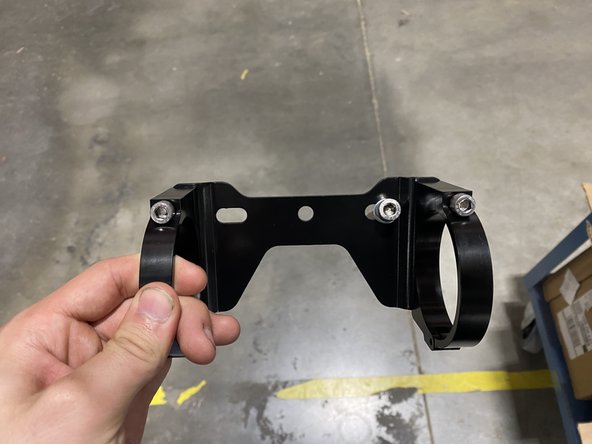 DRIVER SIDE: Slide the small washer on the long 8mm bolt. Insert bolt in the RIGHT HOLE of the bracket assembly.