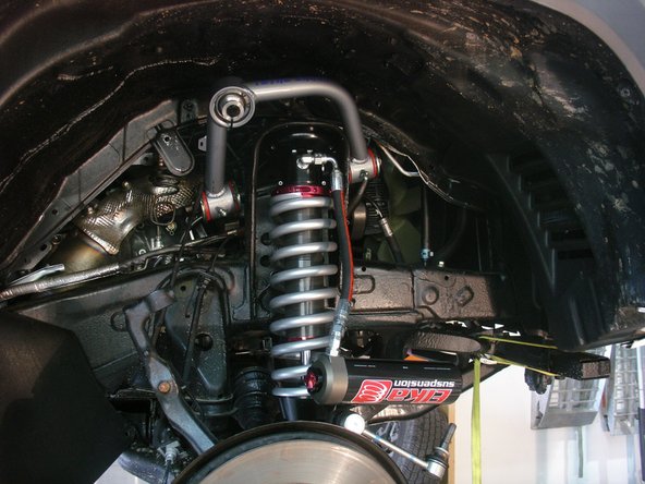 Install Elka shocks with the hose fitting facing the front of vehicle (right side shown)